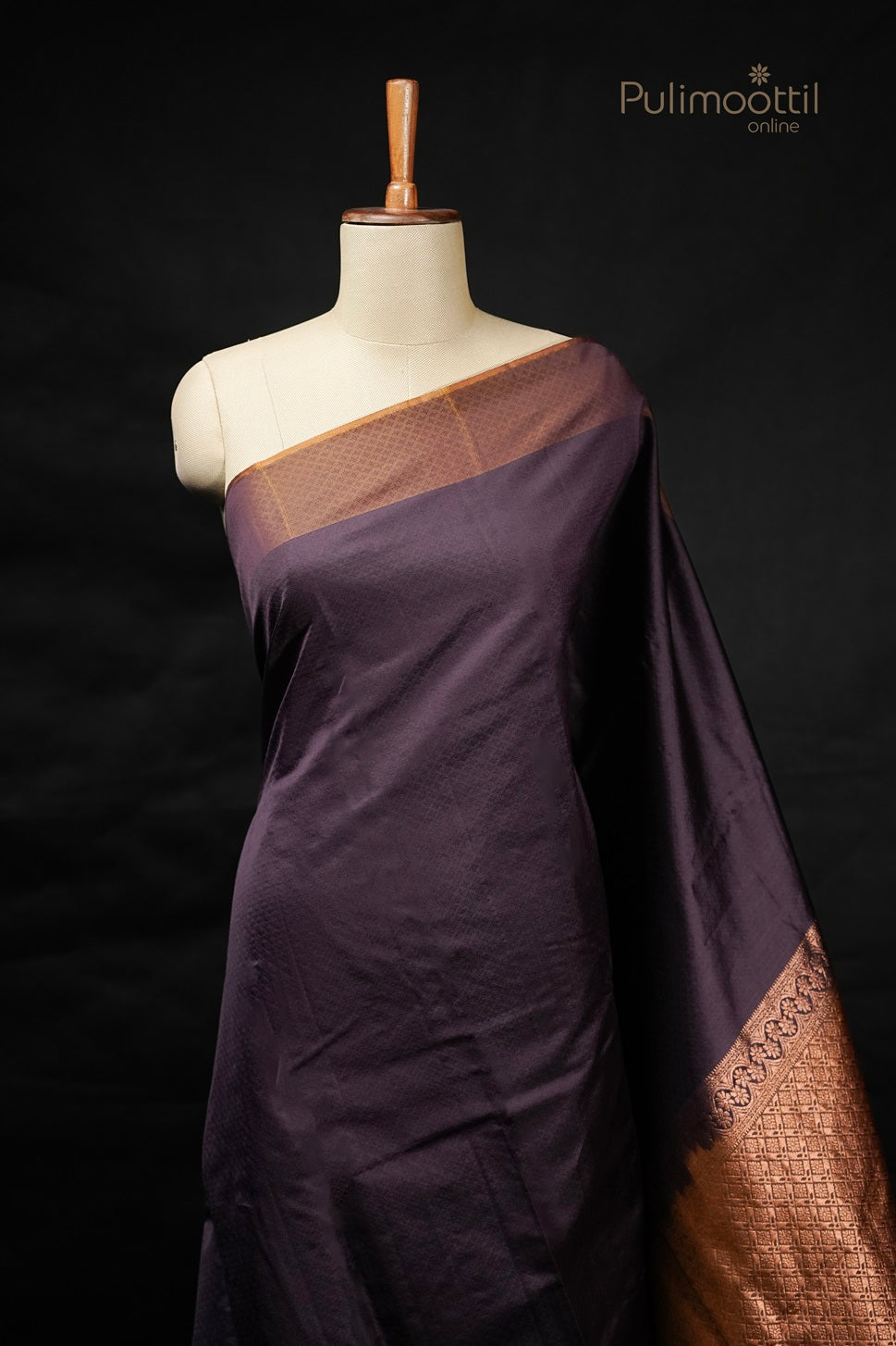 Purple Kanchipuram self print saree with contrast golden yellow pallu draped on mannequin