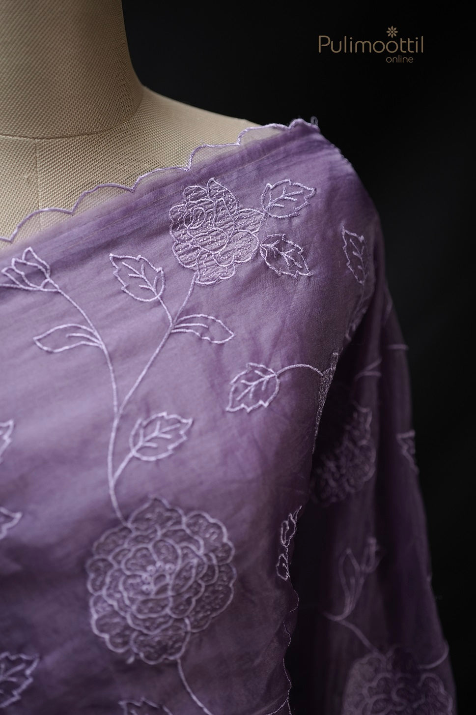Close-up of lavender organza saree scallop border with intricate cut work and embroidery, showcasing elegant floral patterns for wedding and bridal sarees by Pulimoottil Silks Thrissur.