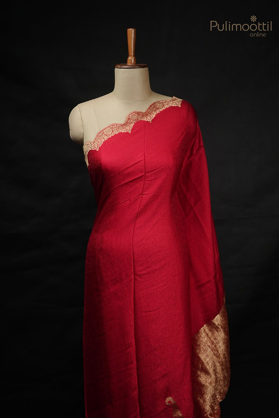 Chili red Banarasi silk saree with golden scallop border draped on mannequin