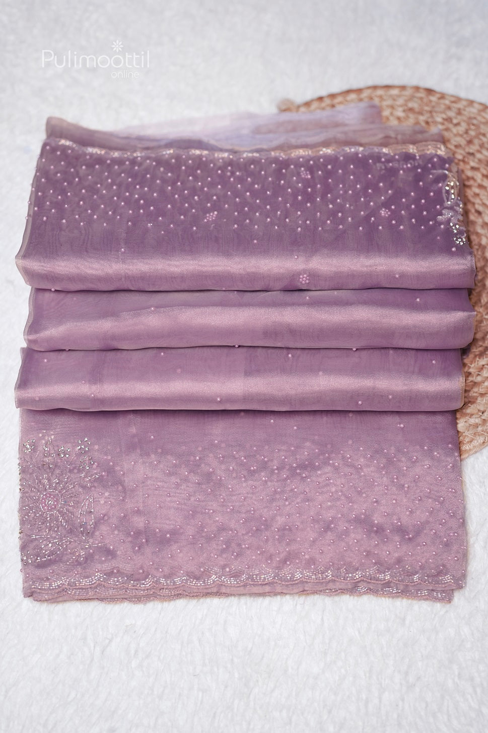 Detailed view of the lavender saree's beadwork and scallop border, showcasing its intricate craftsmanship.